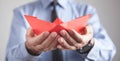 Man holding red origami paper boat Royalty Free Stock Photo