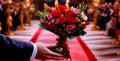 Man holding red rose flower on wedding day