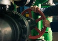 Man holding red valves in technical room Royalty Free Stock Photo