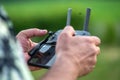 A man holding a remote control of a drone in his hand, close-up Royalty Free Stock Photo