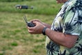 A man holding a remote control of a drone in his hand, close-up Royalty Free Stock Photo