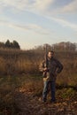 Man holding rifle in fields Royalty Free Stock Photo