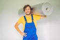 man holding a roll of insulating cloth to install a laminate wooden floor