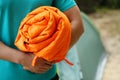 Man holding rolled sleeping bag outdoors