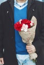 Man holding a romantic flower bouquet, close up