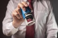 Man holding rubber stamp close up. Businessman certify documents