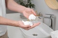 Man holding shaving foam in bathroom, closeup