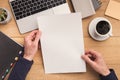 Man holding sheet of paper at workplace Royalty Free Stock Photo