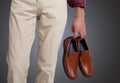 Man holding the shoes in hand Royalty Free Stock Photo