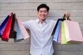 Man holding shopping bag look at camera and smile, shopping concept