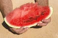 Man holding a slice of juicy watermelon.Tasty fruit snack