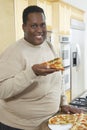 Man Holding Slice Of Pizza