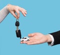 Man holding small car, woman holding car key Royalty Free Stock Photo