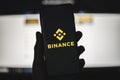 Binance icon on phone with official website background Royalty Free Stock Photo