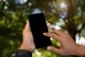 Man holding smartphone with blank screen, close-up of hands. Space for text Royalty Free Stock Photo