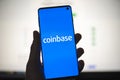 Coinbase icon on phone with official website background