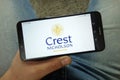 Man holding smartphone with Crest Nicholson housebuilding company logo