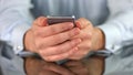 Man holding smartphone in hands closeup reading news, modern technology, app