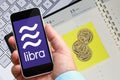 Man holding a smartphone in his hand with the libra logo, the new crypto currency created by facebook company Royalty Free Stock Photo