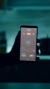 Man holding smartphone with lighting control application, turning on the lights Royalty Free Stock Photo