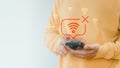 Man holding a smartphone with no Wi-Fi connection icon, symbolizing internet disconnection, network error Royalty Free Stock Photo
