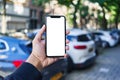 Man holding smartphone showing white blank screen at car parking Royalty Free Stock Photo