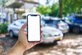 Man holding smartphone showing white blank screen at car parking Royalty Free Stock Photo