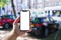 Man holding smartphone showing white blank screen at car parking Royalty Free Stock Photo