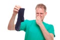 Man holding smelly socks and clogged nose Royalty Free Stock Photo