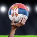 Man holding Soccer ball with Serbian flag Royalty Free Stock Photo