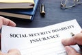 Man holding Social Security Disability Insurance SSDI policy.