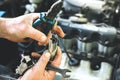 Man holding spark plug in old car engine. Inner details of machine. Repairing of vehicle Royalty Free Stock Photo