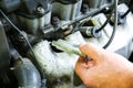 Man holding spark plug in old car engine. Inner details of machine. Repairing of vehicle Royalty Free Stock Photo