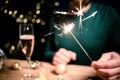 man holding sparkles and champagne glass New Year party Royalty Free Stock Photo