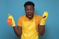 Man holding sponges and washing spray being upset not wanting to do cleaning Royalty Free Stock Photo