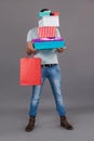 Man holding stack of gift boxes and shopping bag Royalty Free Stock Photo