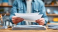 A man is holding a stack of papers in his hand Royalty Free Stock Photo