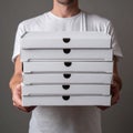 Man Holding Stack of Pizza Boxes Royalty Free Stock Photo