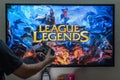 Man holding steam controller in front of a screen loading the popular RPG MMORPG league of legends a much loved popular