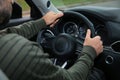 Man holding steering wheel in car, closeup. Driving test Royalty Free Stock Photo