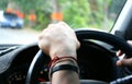 Man holding the steering wheel while driving,left hand Royalty Free Stock Photo