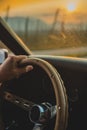 Man holding steering wheel in sunset Royalty Free Stock Photo