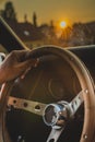 Man holding steering wheel in sunset Royalty Free Stock Photo