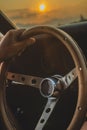 Man holding steering wheel in sunset Royalty Free Stock Photo