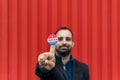 Man holding a sticker with the American flag colors with 'I voted today' written on it Royalty Free Stock Photo