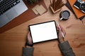 Man holding stylus pen and digital tablet with empty screen on wooden desk. Royalty Free Stock Photo