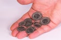 Man`s hand holding Swiss coins on a white background Royalty Free Stock Photo