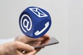 Man holding a tablet and a big blue dice with icons of email SMS and call Royalty Free Stock Photo