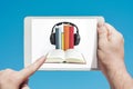 Man holding a tablet device showing audiobooks concept Royalty Free Stock Photo