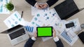 Man holding tablet with green screen, showing company presentation to partner